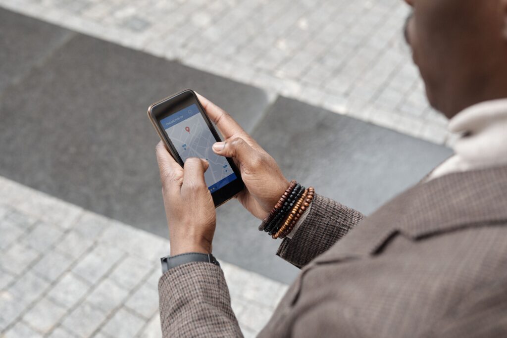 Person checking a navigation map on a smartphone outdoors
