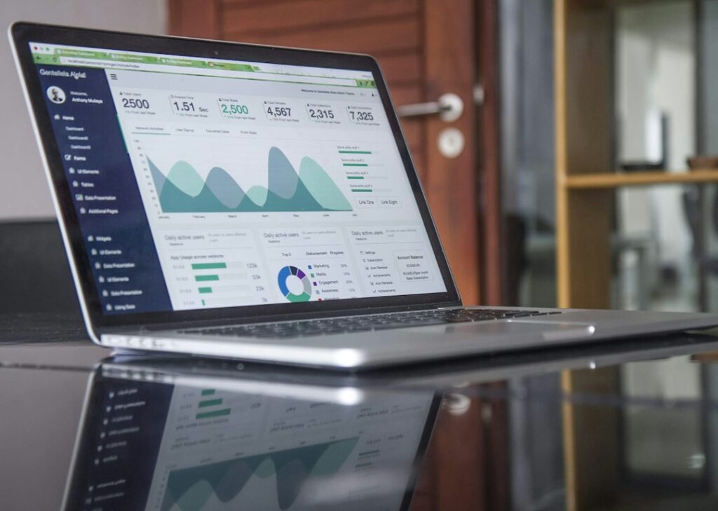 Laptop and notebook on a desk during website performance planning