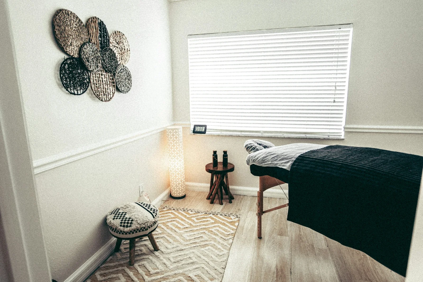 A real treatment room with a treatment bed and soft natural light
