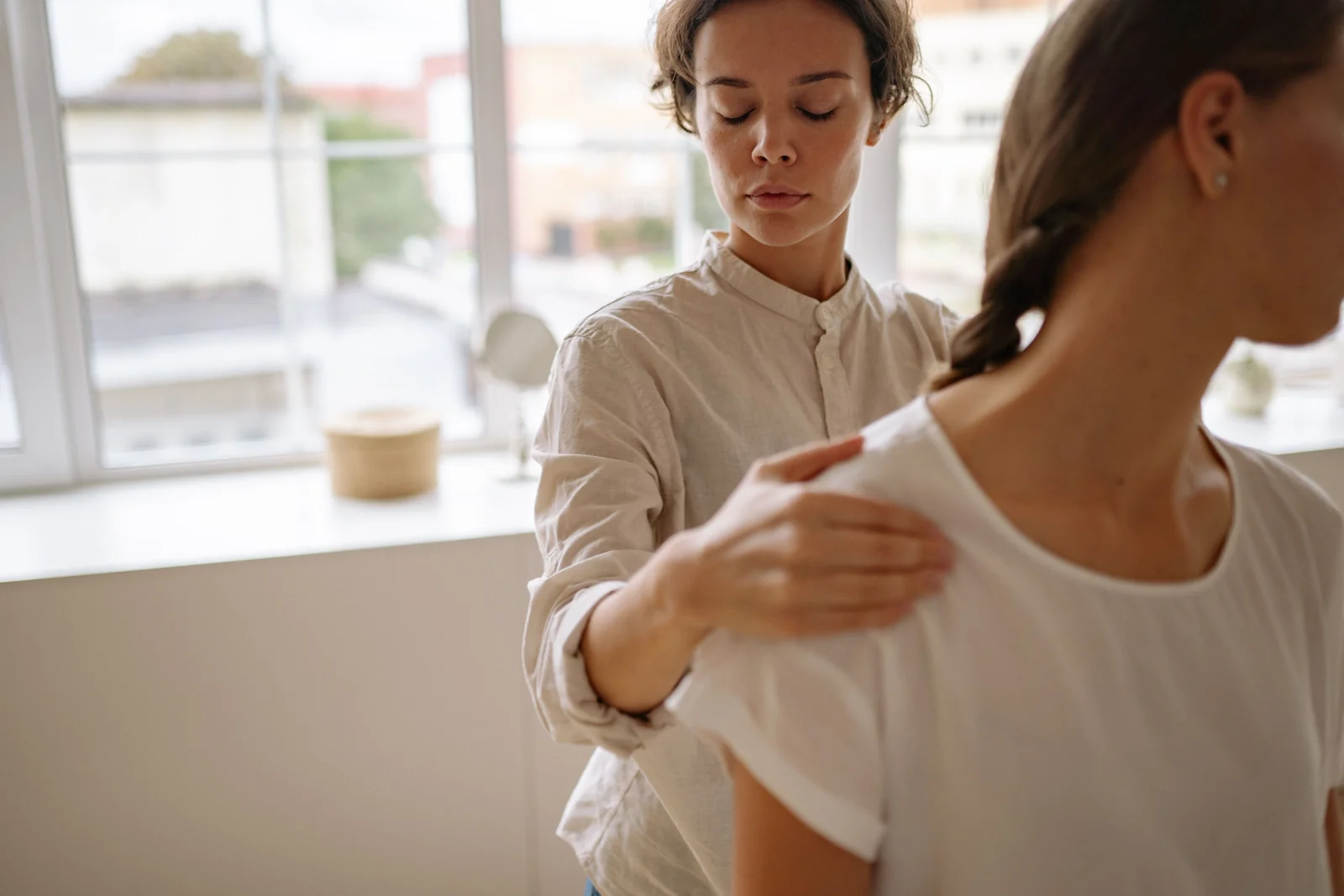 A practitioner assessing a patient's movement in a bright rehabilitation clinic