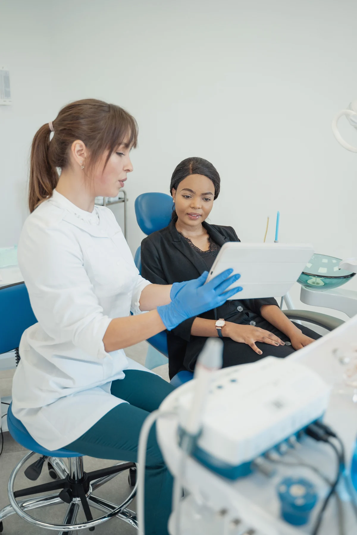 Dental professional talking with a patient about their care