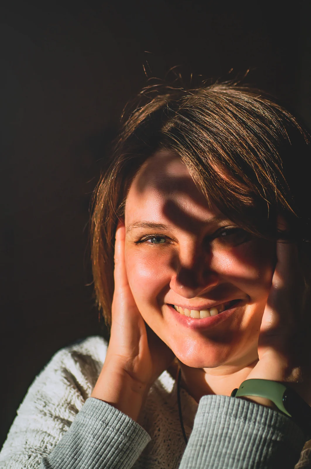 Natural smiling portrait illustrating a warm, personal dental website direction